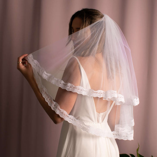 Paula Lace Trim Veil with intricate lace detailing on American tulle, creating a unique and elegant bridal accessory.