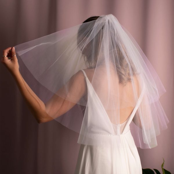 Elegant Serenity Bridal Veil in elbow-length American tulle, enhancing bridal hairstyle with volume and grace.