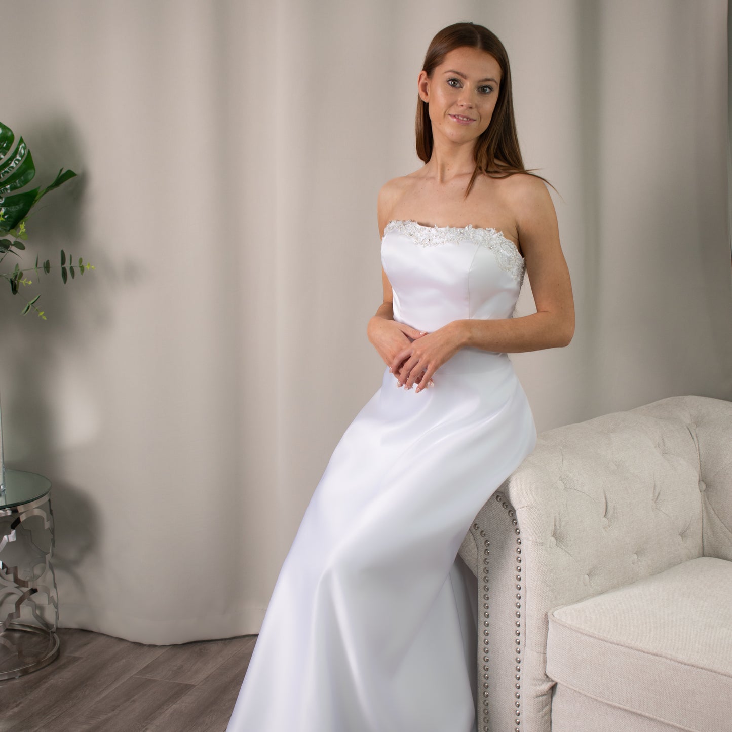Strapless Brittany debutante dress with intricate beaded neckline and flowing A-line silhouette.
