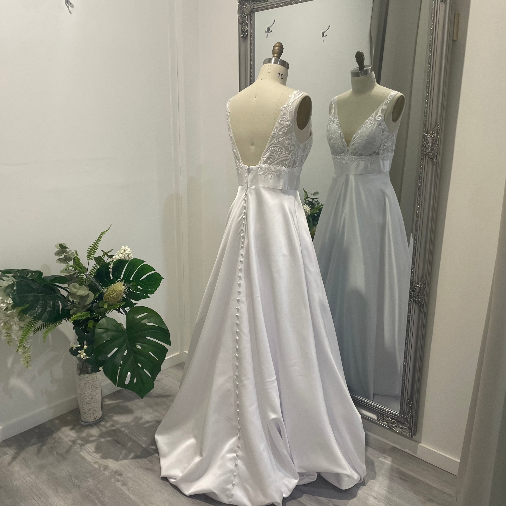 Aria Grace deb dress with lace V-neckline, defined waistband, and flowing A-line skirt