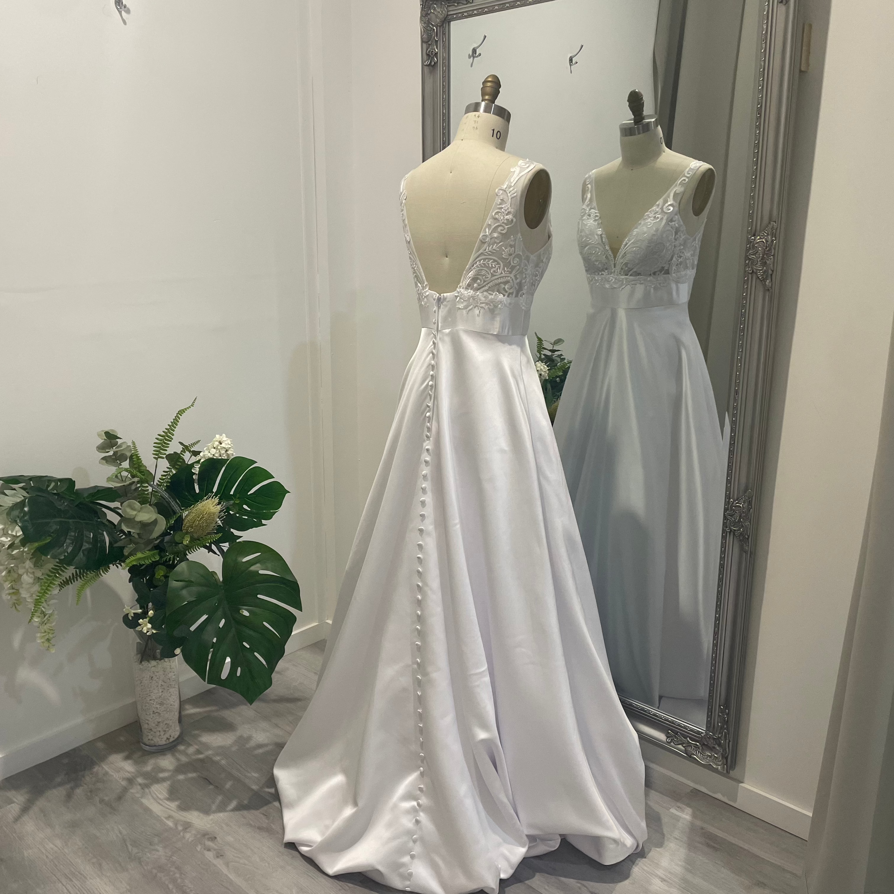 Aria Grace deb dress with lace V-neckline, defined waistband, and flowing A-line skirt