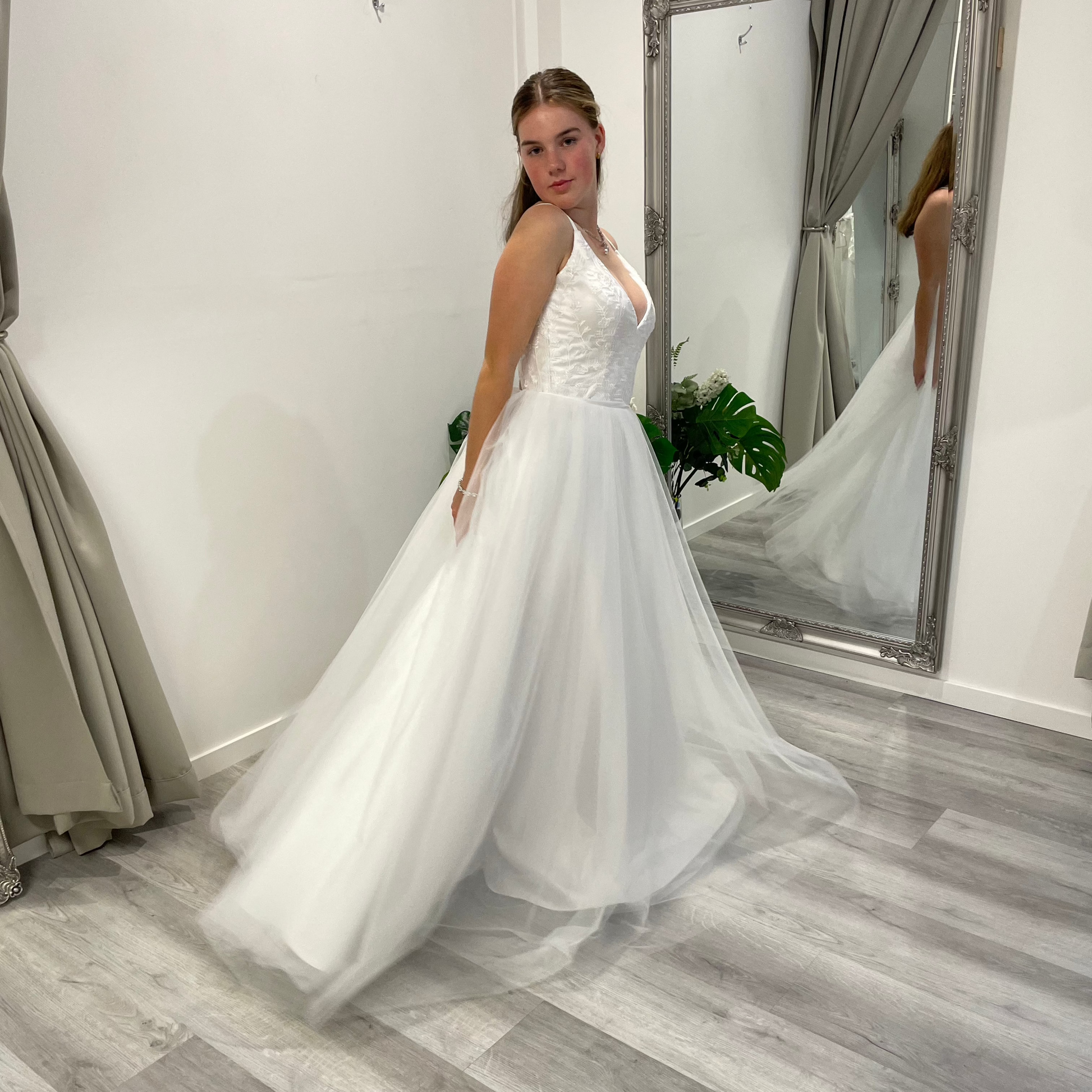 Side front angle of Valentina Lace Essence Deb Dress with a delicate lace corset bodice, flattering silhouette, and an A-line skirt for a classic, elegant appearance.
