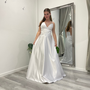 Serene Elegance deb dress in white satin with V-overlap neckline, slim straps, and A-line skirt