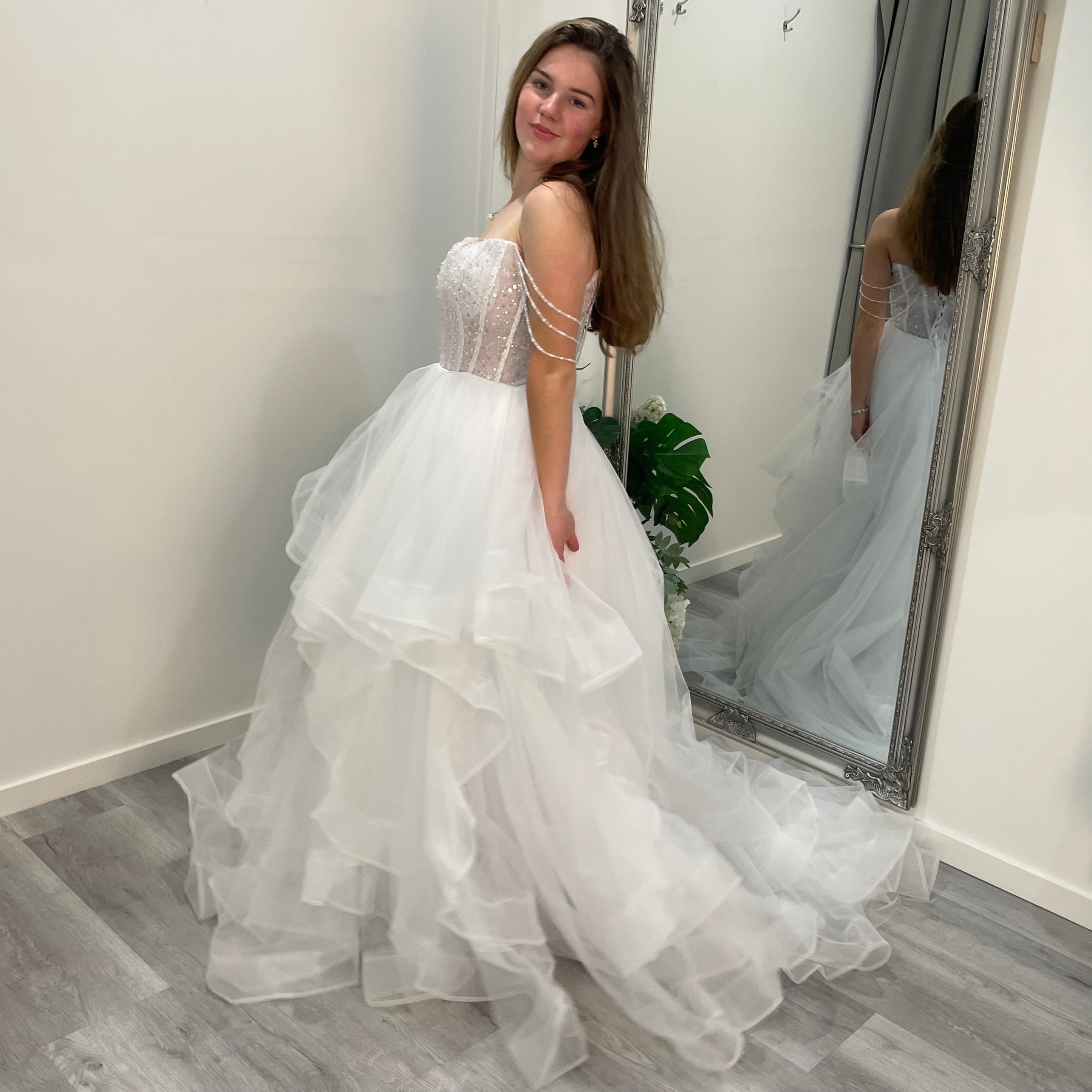 Elowen Debutante Dress featuring a beaded corset bodice with scoop neckline and three dangling beaded straps, paired with a tulle A-line skirt with soft ruffles.