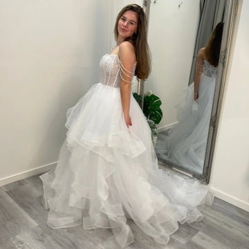 Elowen Debutante Dress featuring a beaded corset bodice with scoop neckline and three dangling beaded straps, paired with a tulle A-line skirt with soft ruffles.