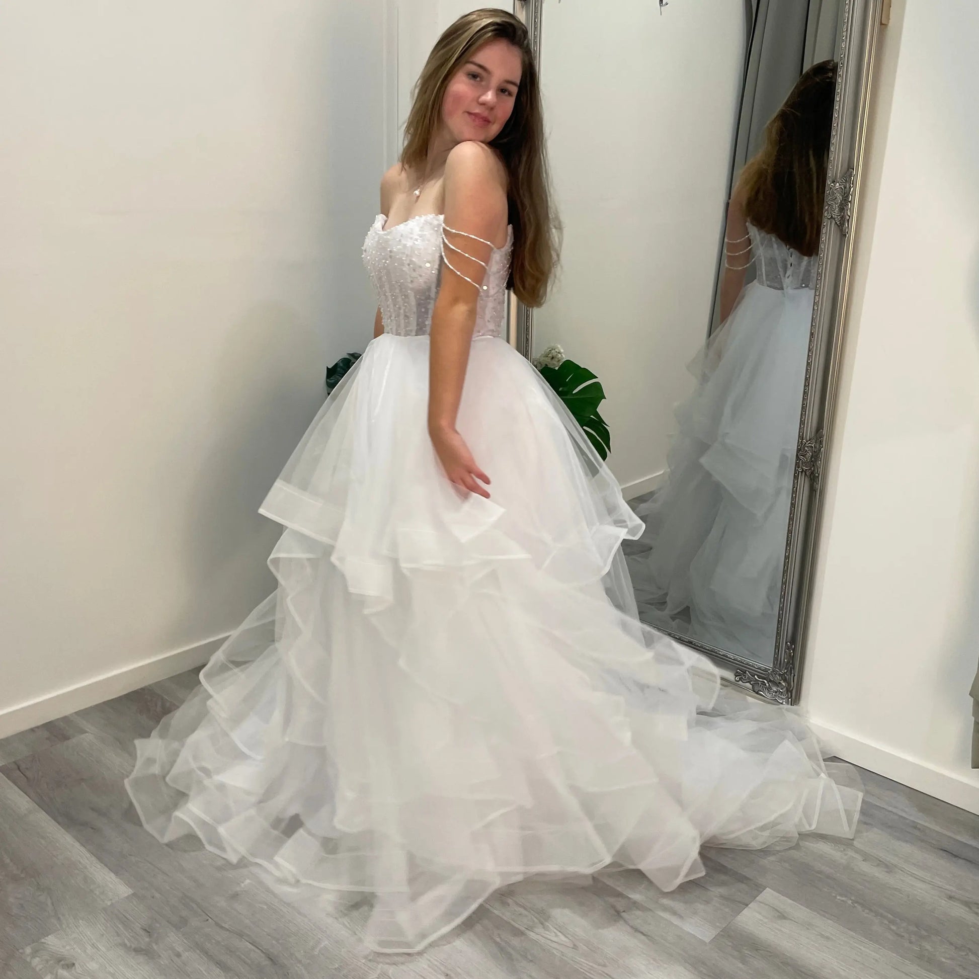 Elowen Debutante Dress featuring a beaded corset bodice with scoop neckline and three dangling beaded straps, paired with a tulle A-line skirt with soft ruffles.