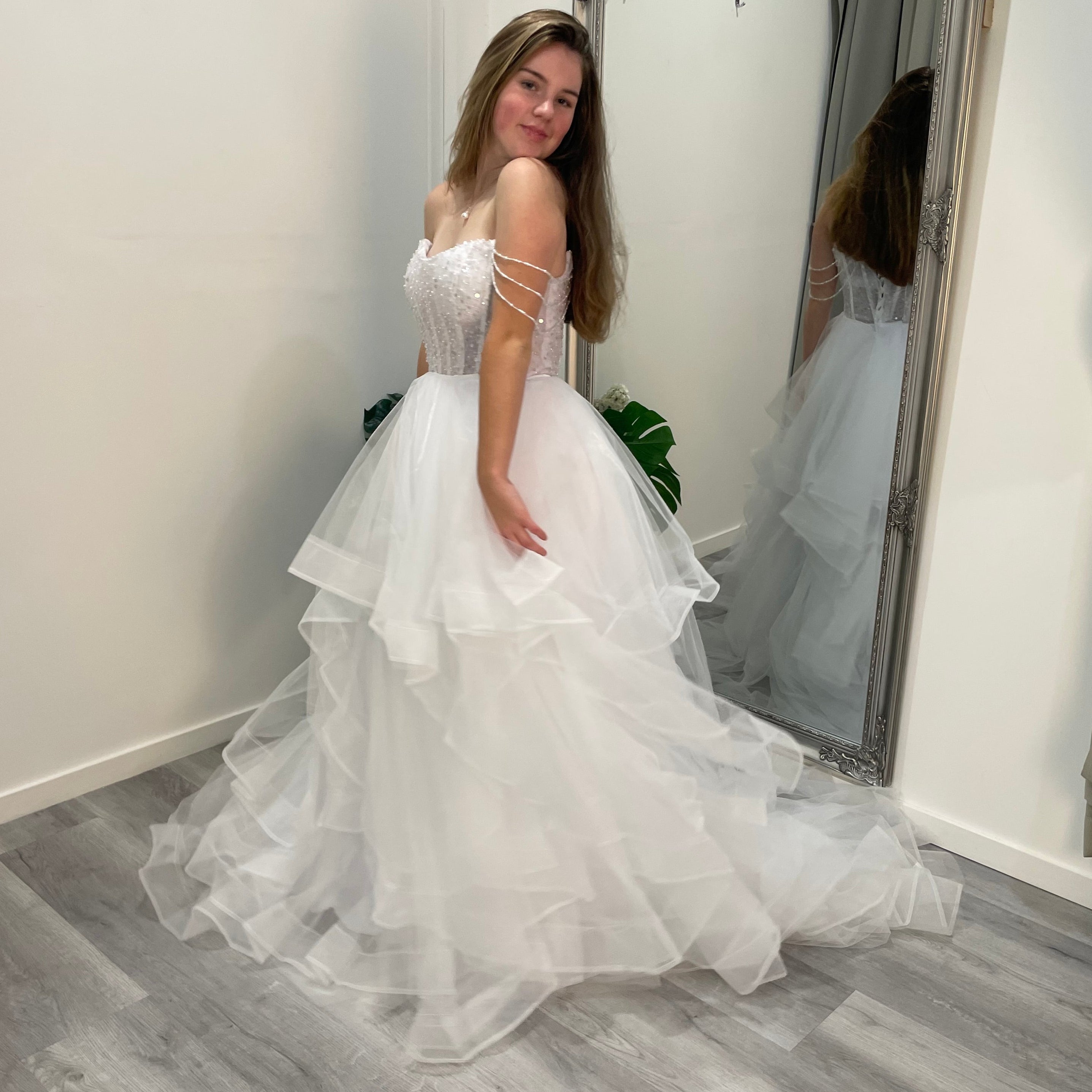 Elowen Debutante Dress featuring a beaded corset bodice with scoop neckline and three dangling beaded straps, paired with a tulle A-line skirt with soft ruffles.