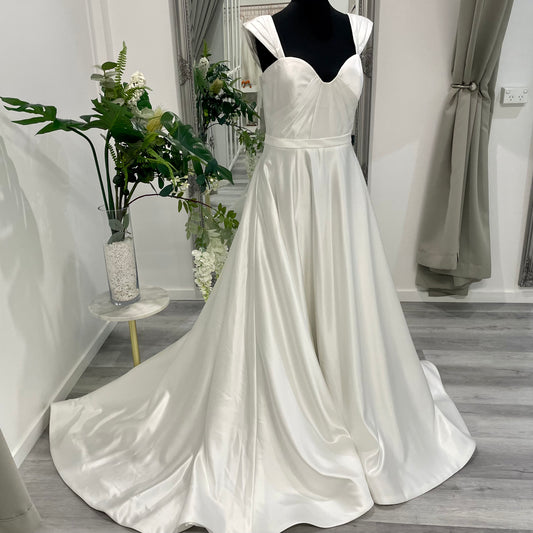 An elegant wedding dress from Divine Bridal A-Line Sweetheart gown, featuring exquisite detailing and a flowing chapel train.