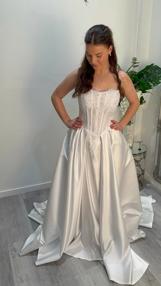 Girl looking down at dress, showing the front