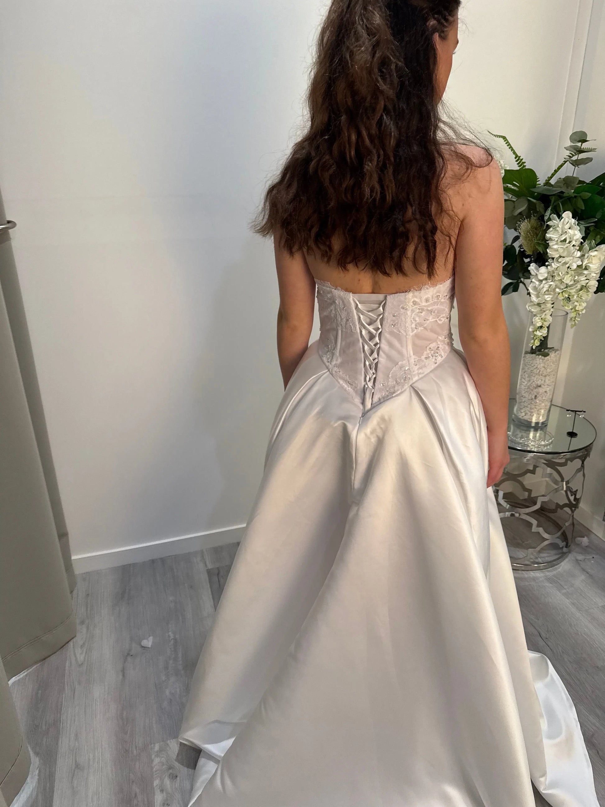 Girl showing the back of the dress with detail