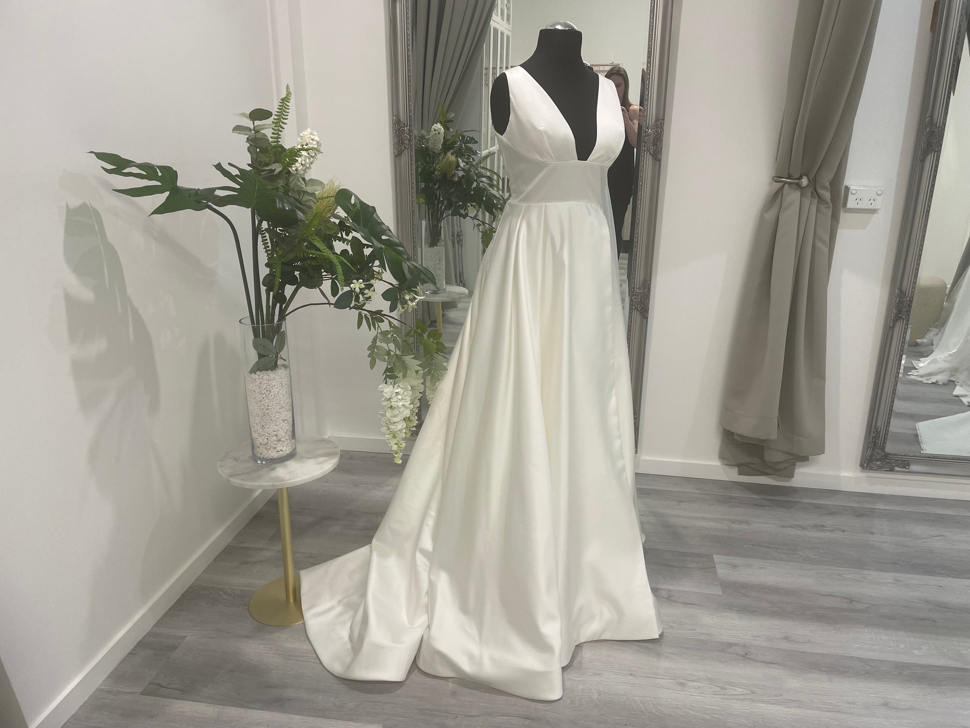 Elegant Darcy Wedding Dress with front skirt split on display at Divine Bridal.