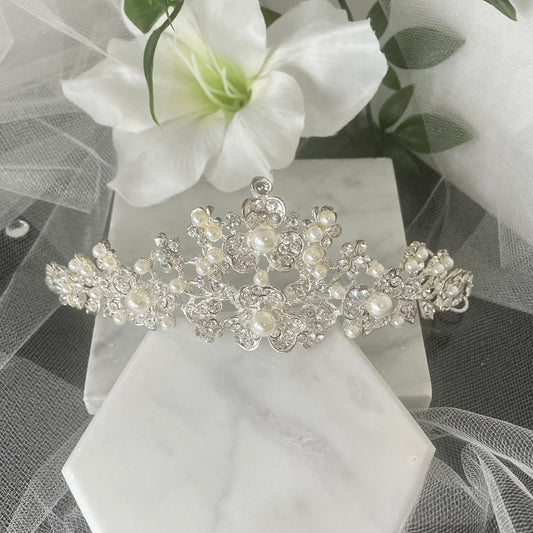 Rosita Bridal Tiara featuring a luxurious floral design adorned with sparkling Diamantés and pearls, perfect for achieving a radiant and regal wedding day look.