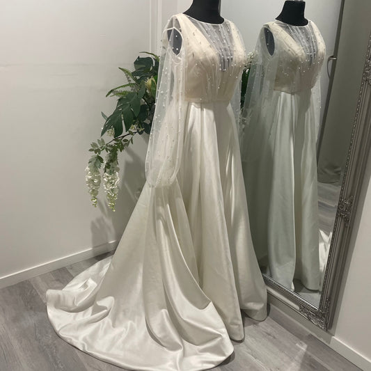Front view of the Darcy bridal topper featuring pearl tulle with elegant front draping and mutton sleeves, perfect for sophisticated bridal wear.