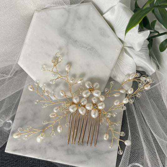 Adalynn Pearl and Crystal Wedding Comb featuring three flowers with diamanté centers and gold wiring, perfect for adding luxurious elegance to bridal hairstyles.