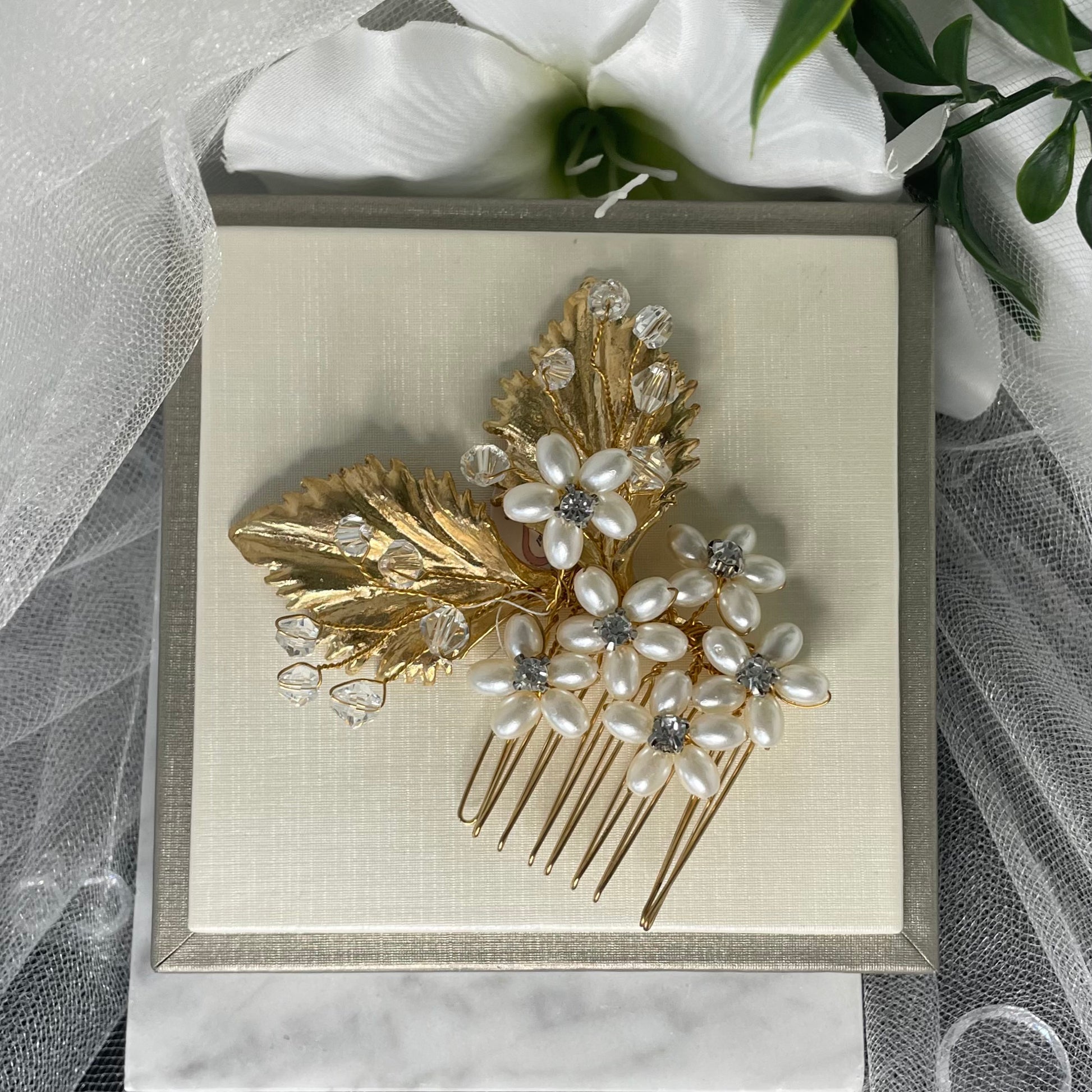 Exquisite Salina Crystal and Pearl Hair Comb featuring pearl flowers with Diamanté centers and gold leaves, perfect for adding a luxurious touch to bridal hairstyles.