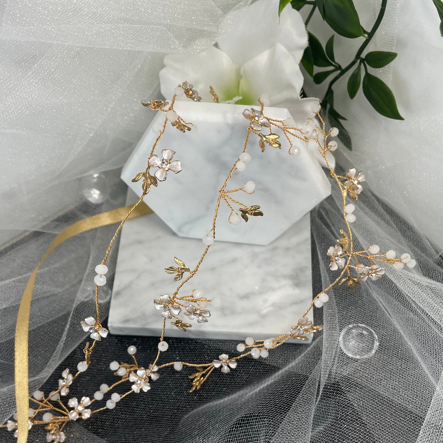 Stunning Eternal Wedding Hair Vine adorned with sparkling crystals on a goldish Rosegold wire, featuring a delicate leaf and floral design, perfect for enhancing bridal hairstyles with natural elegance.