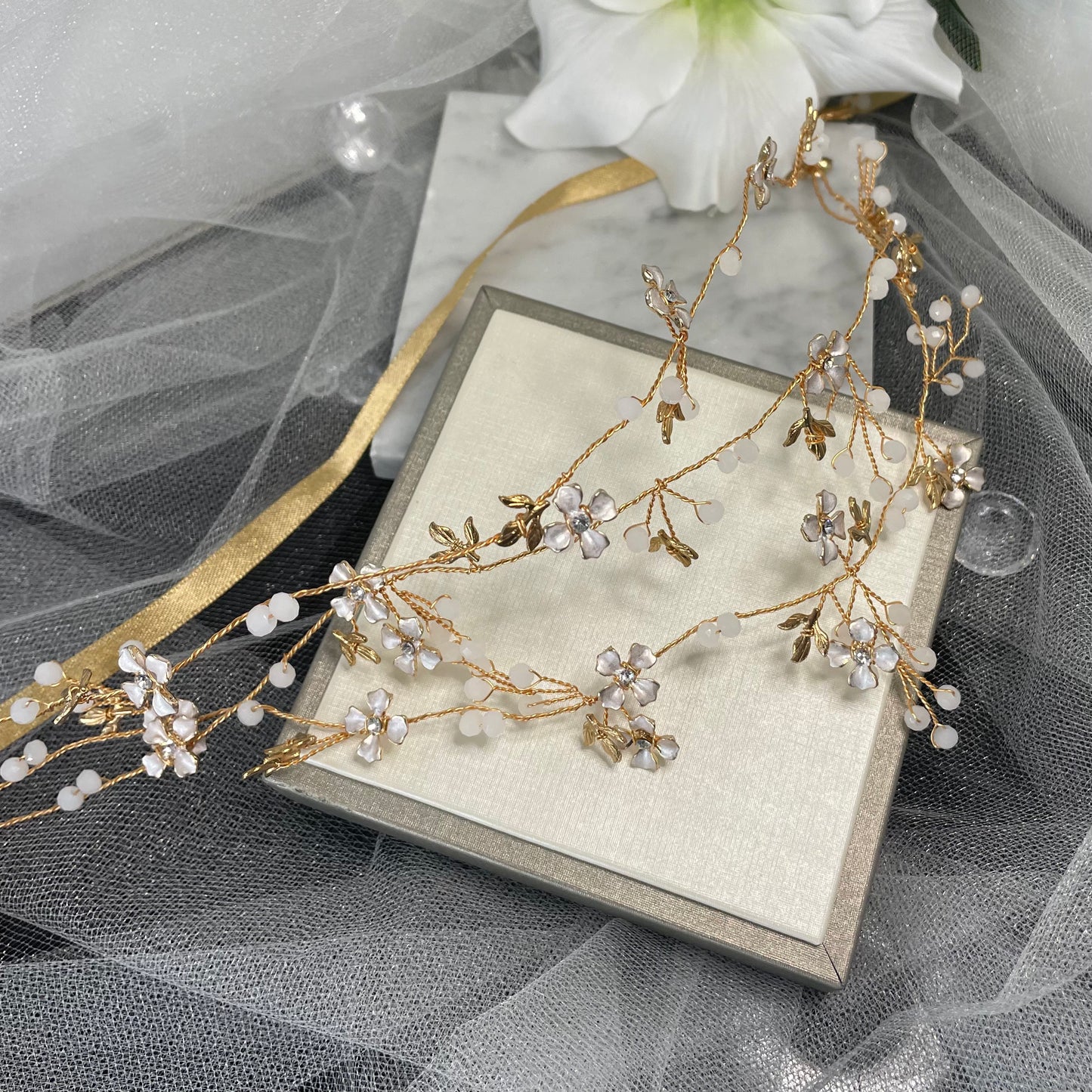 Stunning Eternal Wedding Hair Vine adorned with sparkling crystals on a goldish Rosegold wire, featuring a delicate leaf and floral design, perfect for enhancing bridal hairstyles with natural elegance.