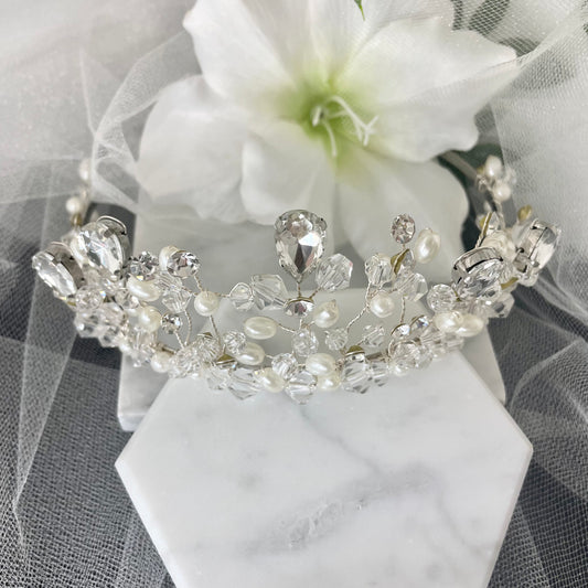 Amara Bridal Tiara adorned with shimmering crystals and pearls, showcasing intricate beadwork and a graceful peak, perfect for enhancing any bridal or formal look.