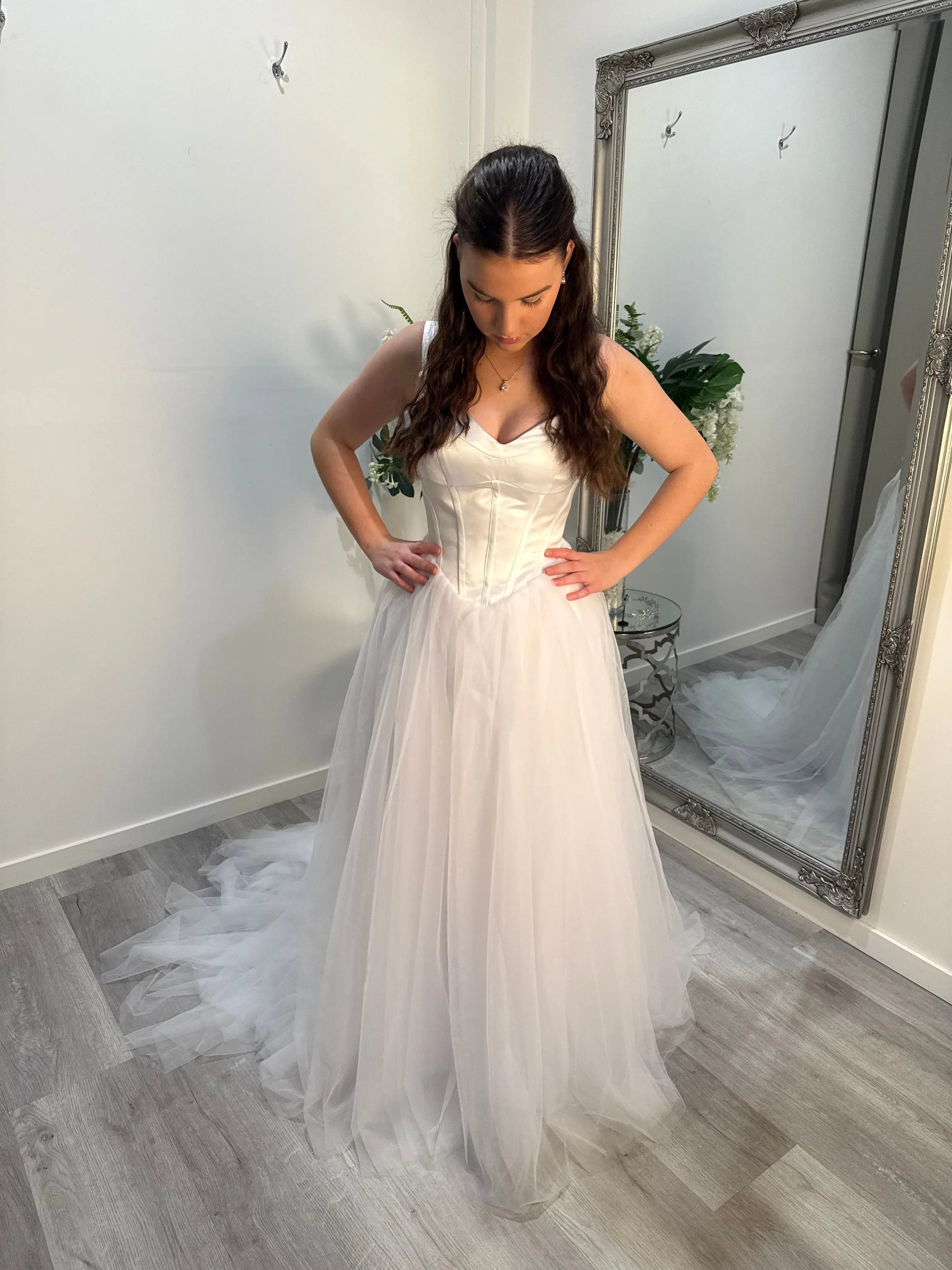 Woman standing in front of the camera, showing off the front of the dress