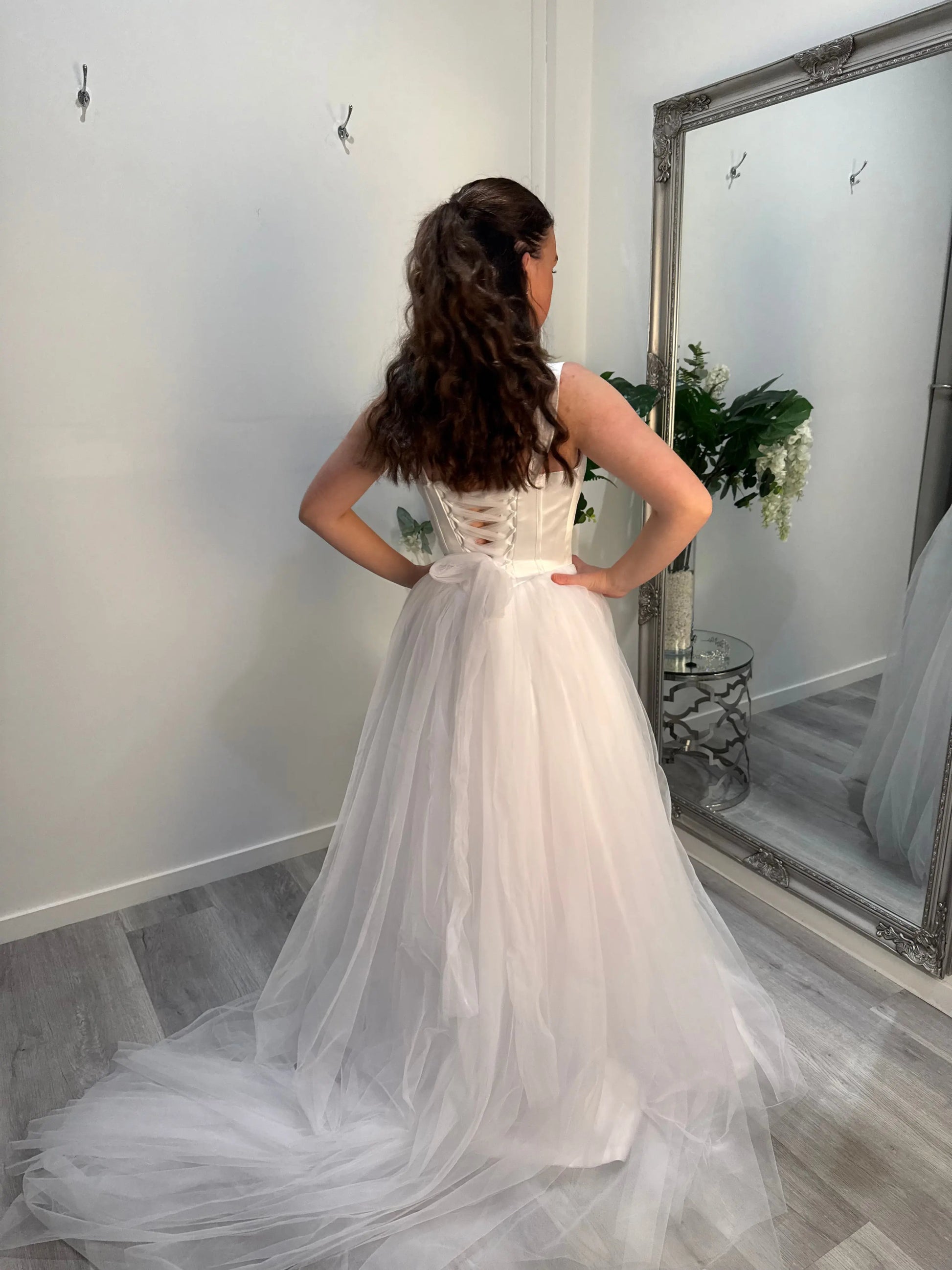 Woman facing away from camera, showing the back of the dress