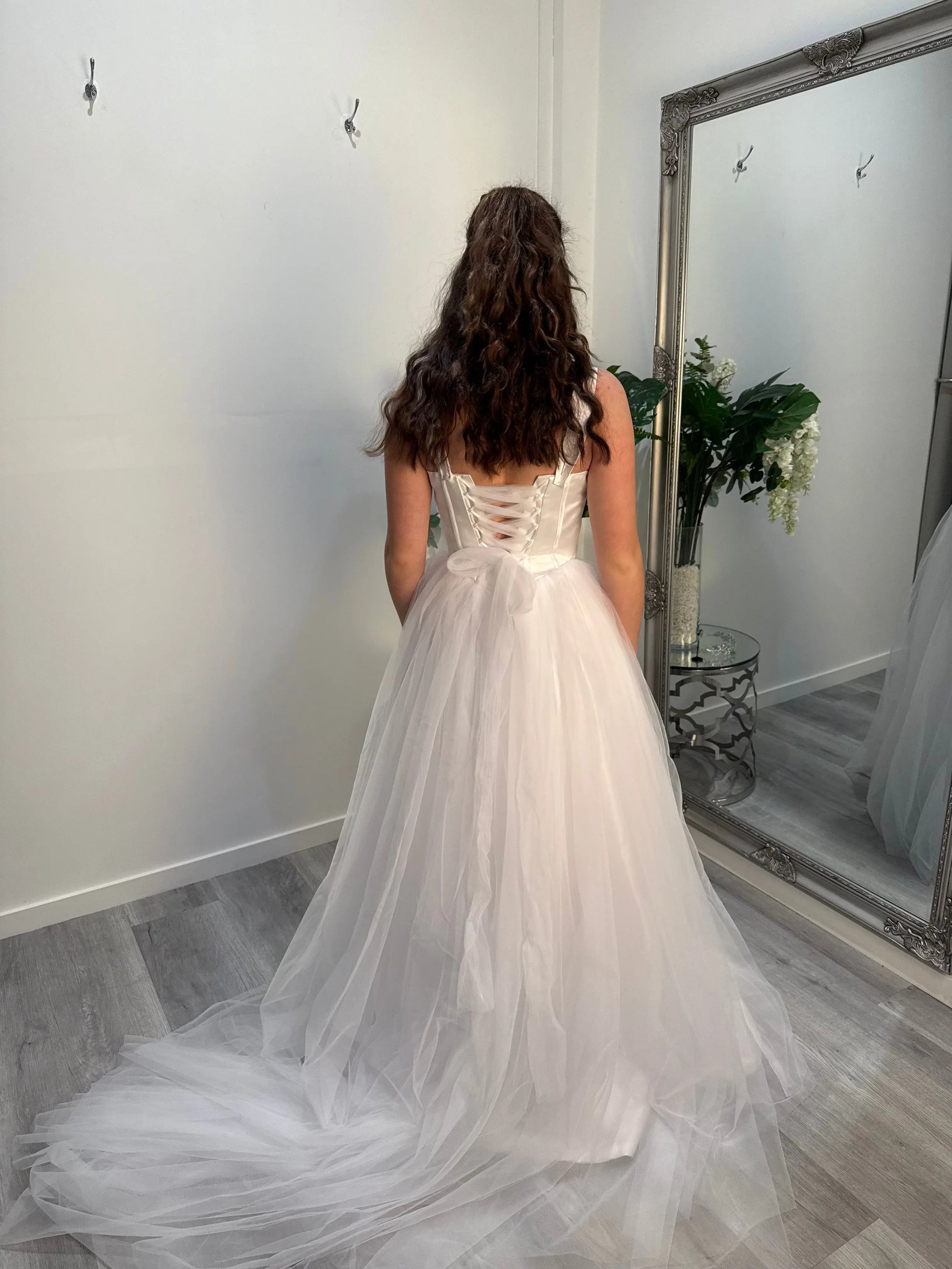 Woman back towards the camera, showing off the back.
