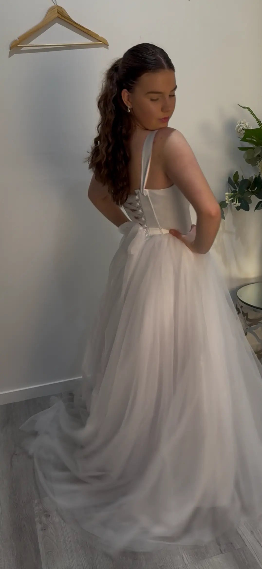 woman standing side on showing the side and back of the dress
