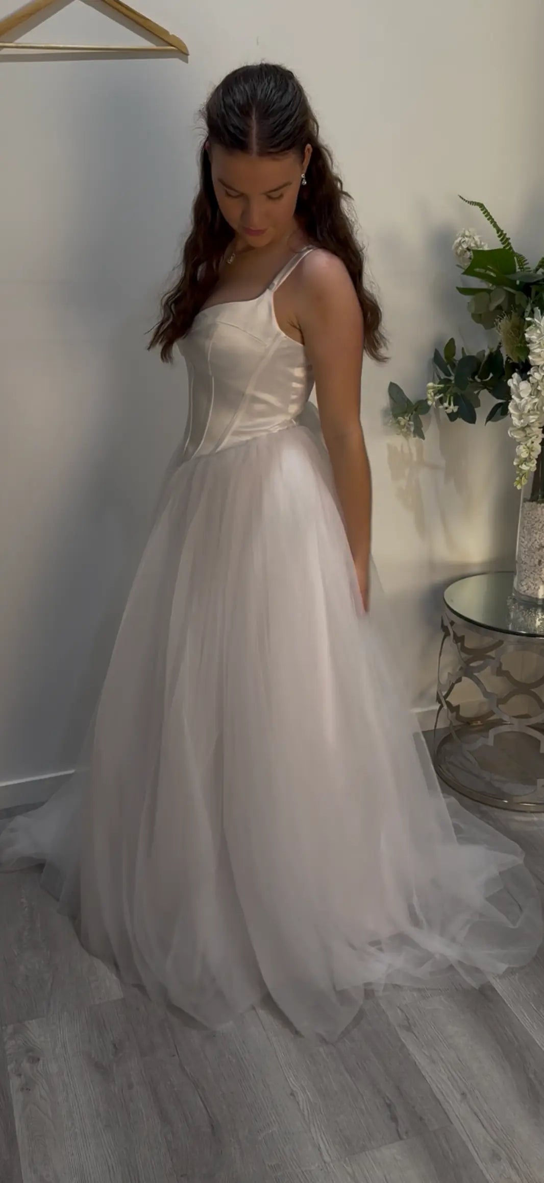 Woman in the Ivy dress standing side on looking down at the dress