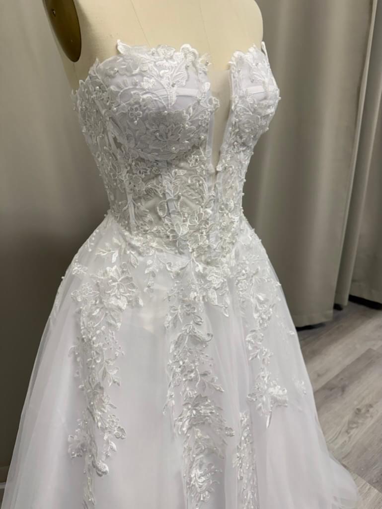 Josie Lace Appliqué Strapless Debutante Gown close-up of lace appliqués and structured corset bodice