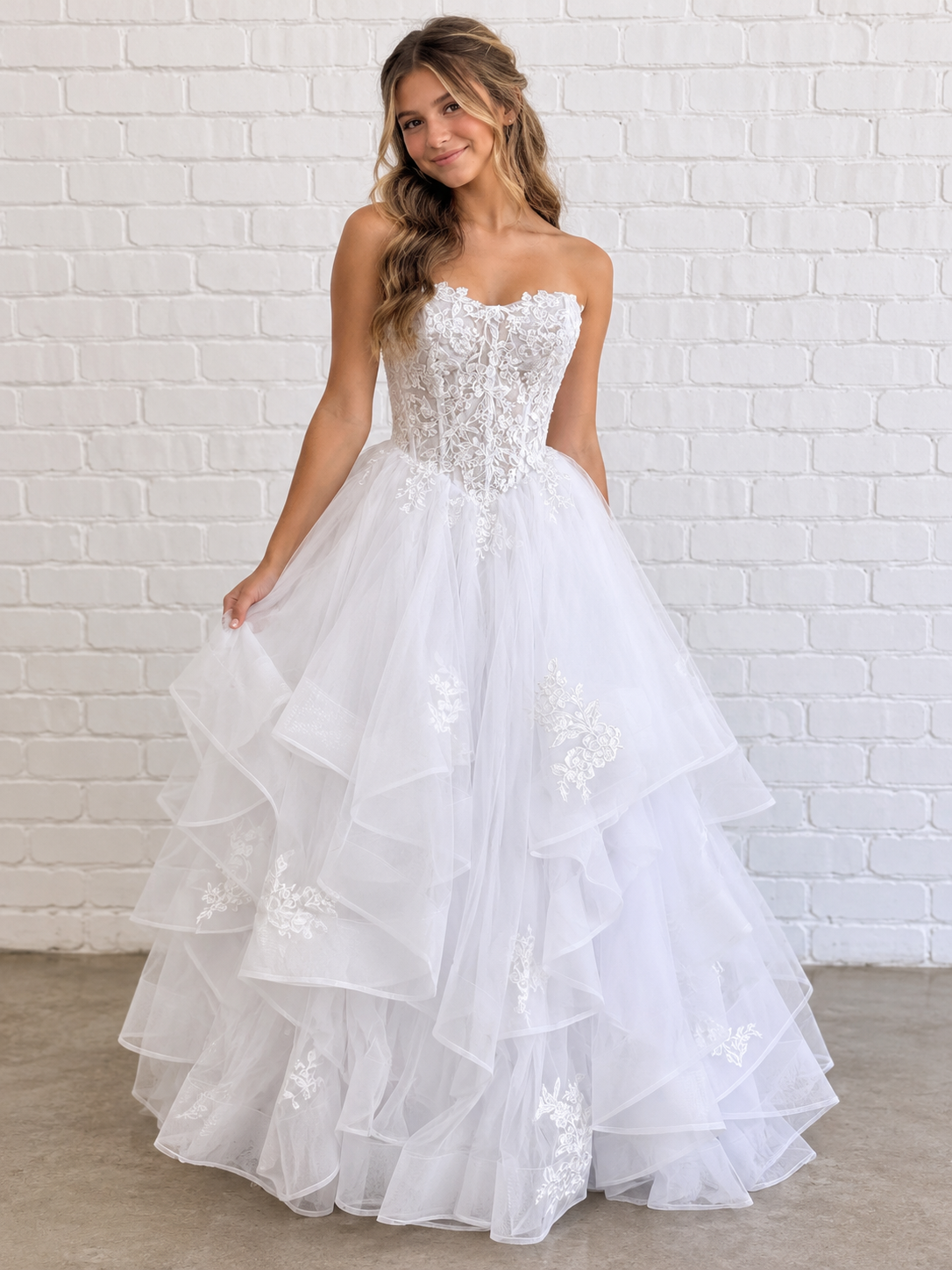 Kasey V1 white lace appliqué debutante dress, front view on model with floral lace corset and full ruffle skirt