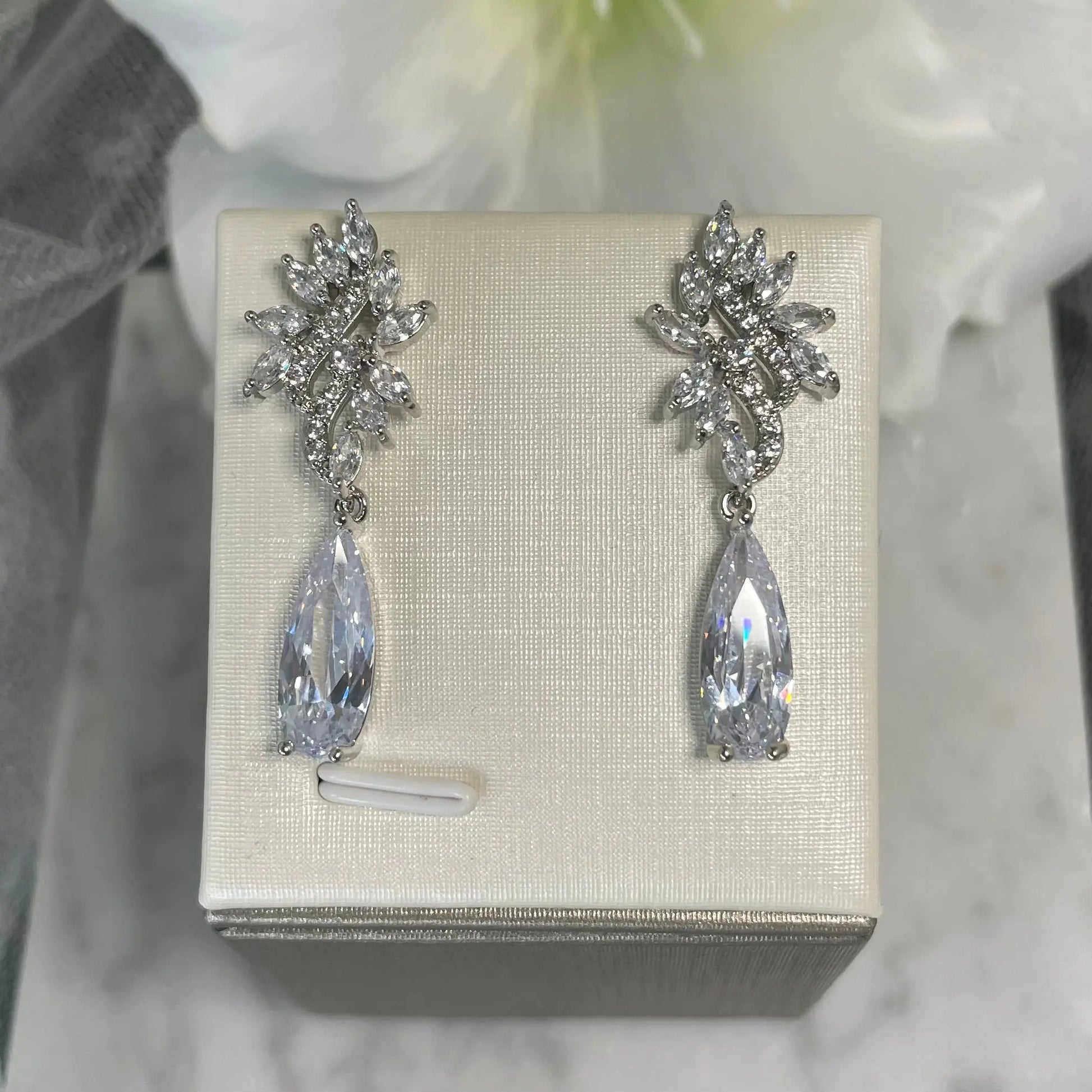 Kirsty Silver Earrings: Wavy Leaf Design with Teardrop Crystal.