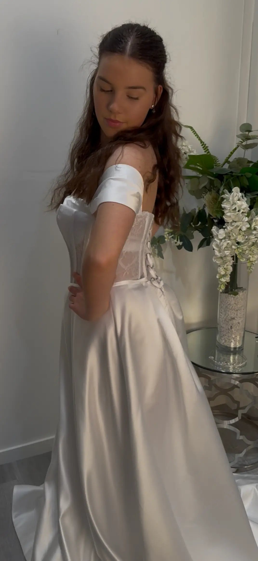 Girl in dress showcasing the side of the dress.