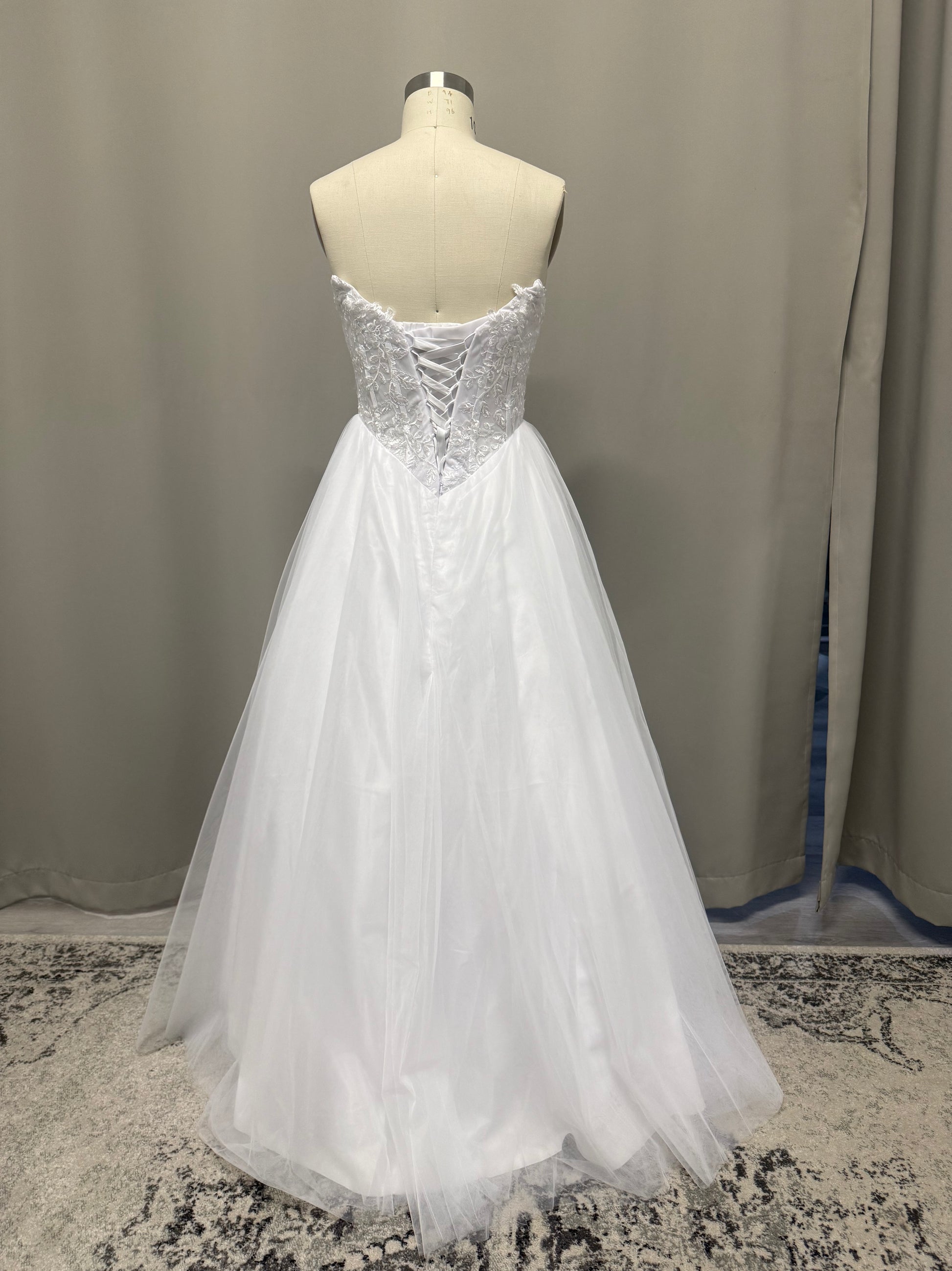Leona V1 embroidered corset debutante dress back view showing lace-up corset, scroll lace and full white tulle skirt
