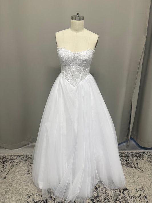 Leona V1 white embroidered corset debutante dress, front view on mannequin with strapless lace bodice and full tulle skirt