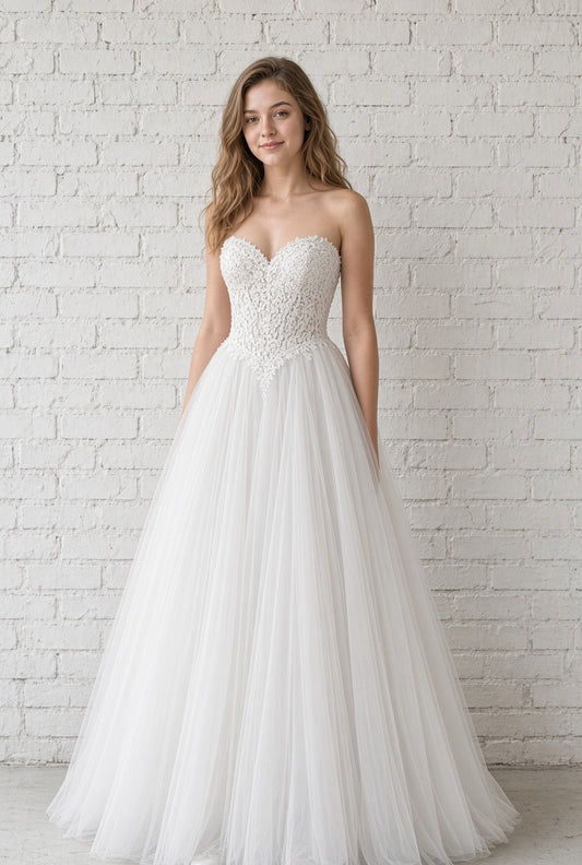 Leona V1 white embroidered corset debutante dress, front view on model with strapless lace bodice and full tulle skirt