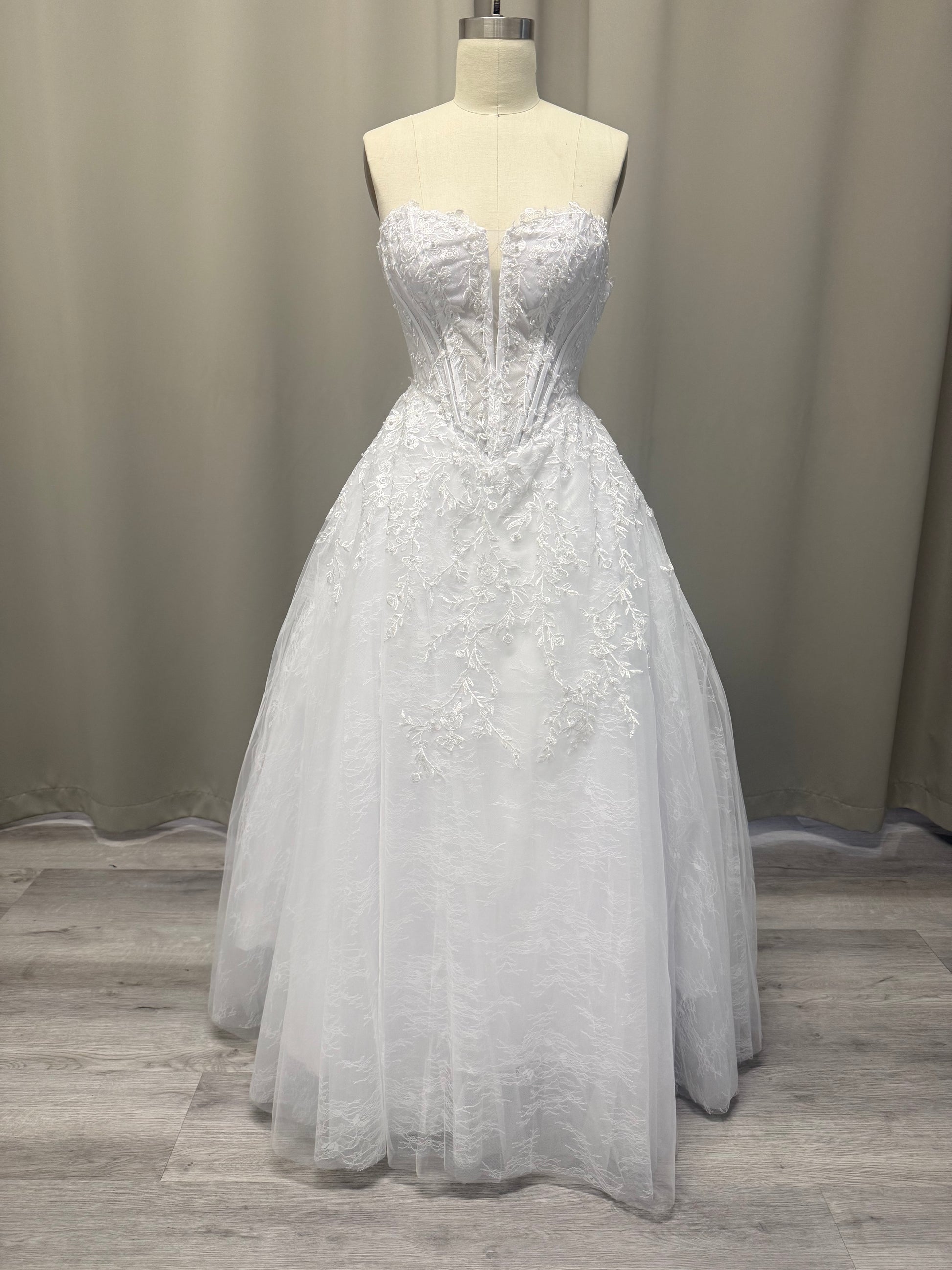 Lilly white strapless lace appliqué deb ball dress, front view on mannequin with sweetheart bodice, pearl detail and full tulle skirt