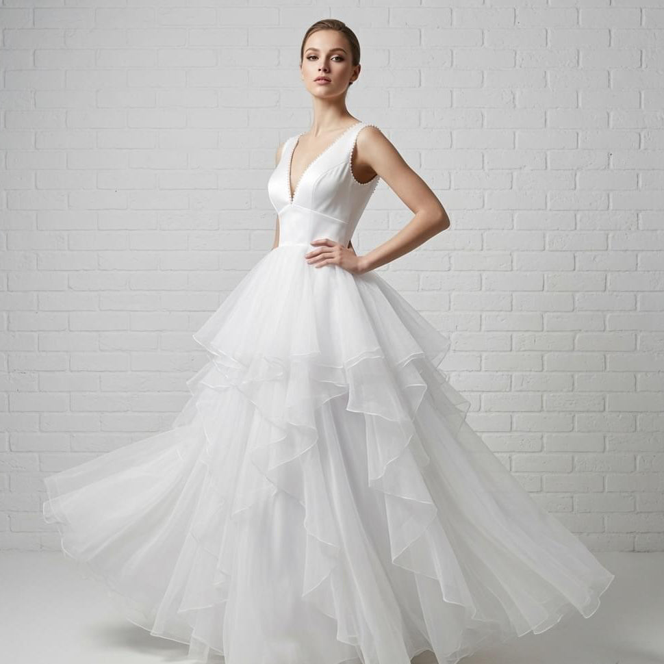 Elegant white V-neck sleeveless satin debutante dress with pearl-beaded neckline and full flowing skirt.