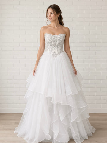 Loretta V1 white pearl debutante dress, front view on mannequin with lace corset and full ruffle skirt