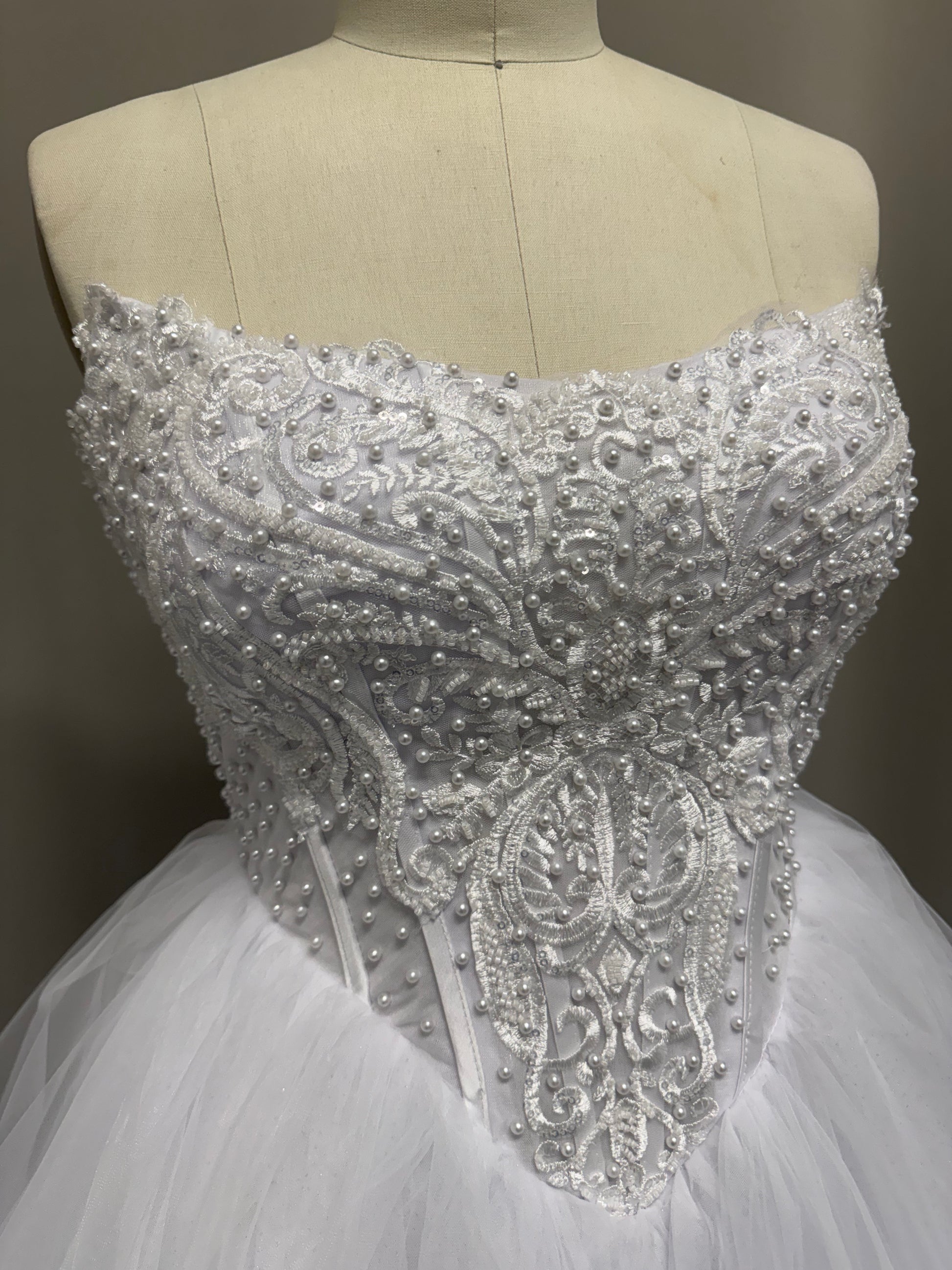 Loretta Lace Beaded Strapless Ruffled Tulle Debutante Ball Gown side view highlighting lace details and high-low skirt