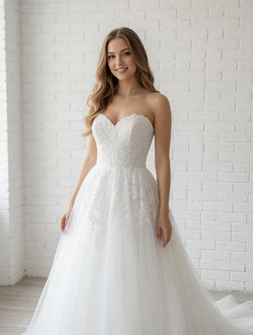 Elegant white debutante dress with a fitted lace bodice, sweetheart neckline and soft layered tulle skirt.