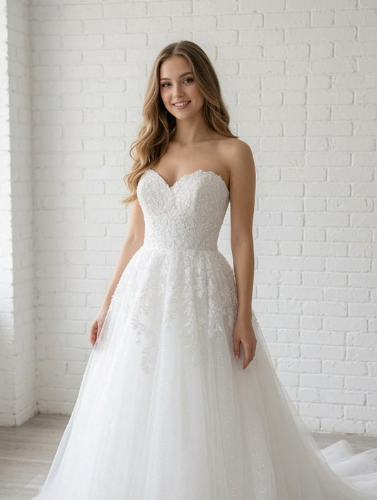 Elegant white debutante dress with a fitted lace bodice, sweetheart neckline and soft layered tulle skirt.