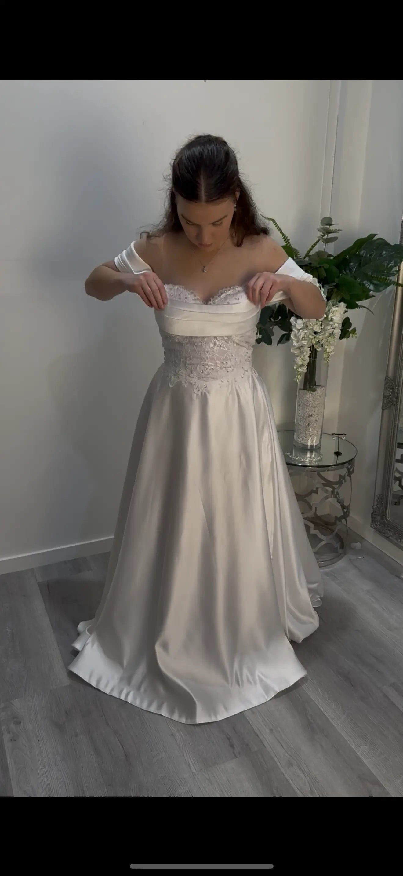Woman wearing a white debutante dress in a room with a neutral background