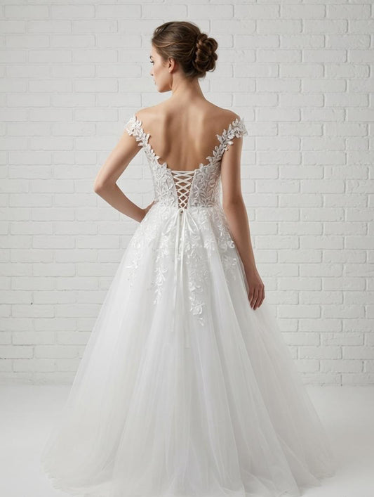 Back view of elegant white floral lace appliqué debutante dress with open back and lace-up closure.
