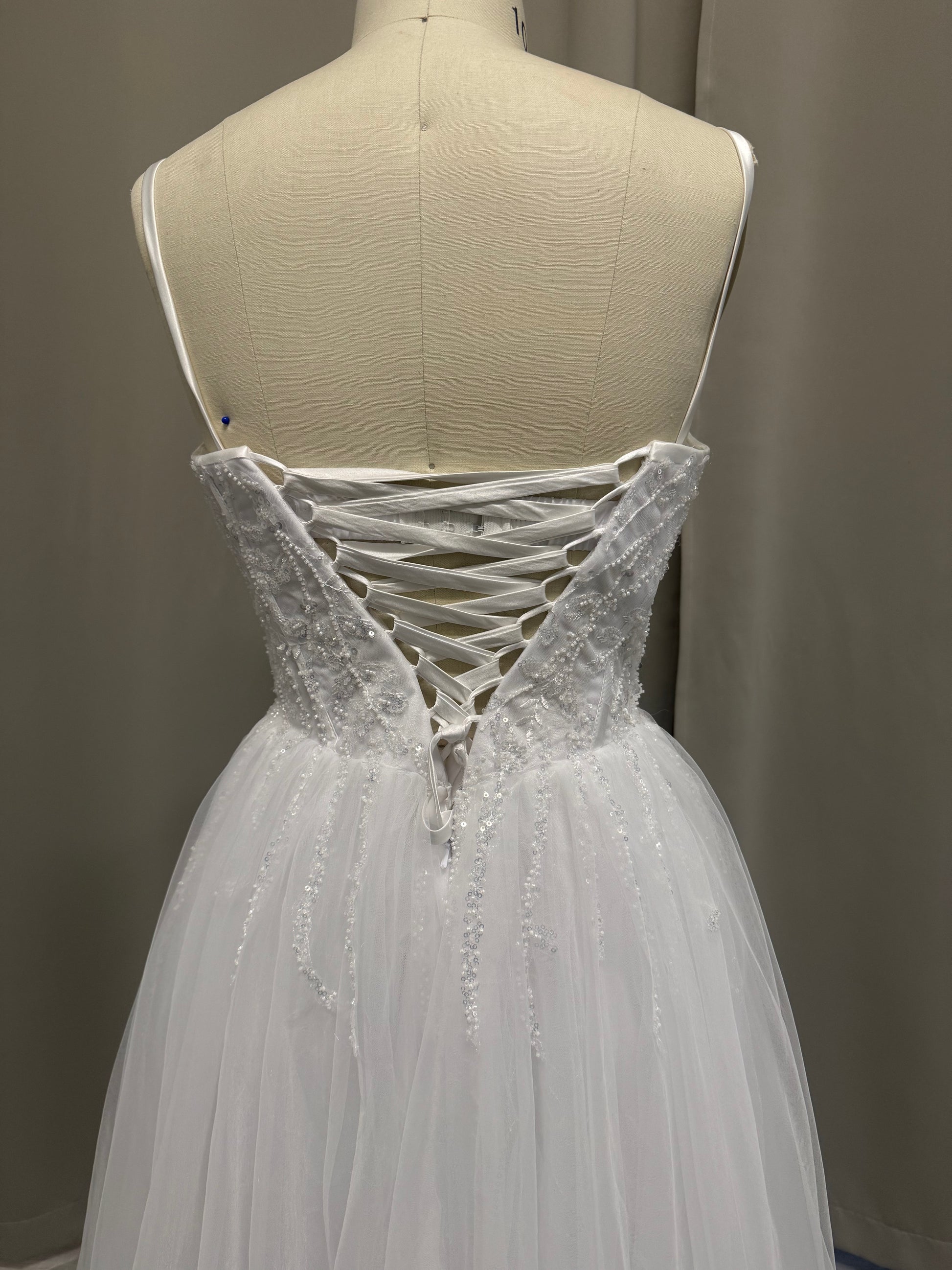 Molly V1 spaghetti strap debutante dress back view showing lace-up corset, beaded lace and full white tulle skirt
