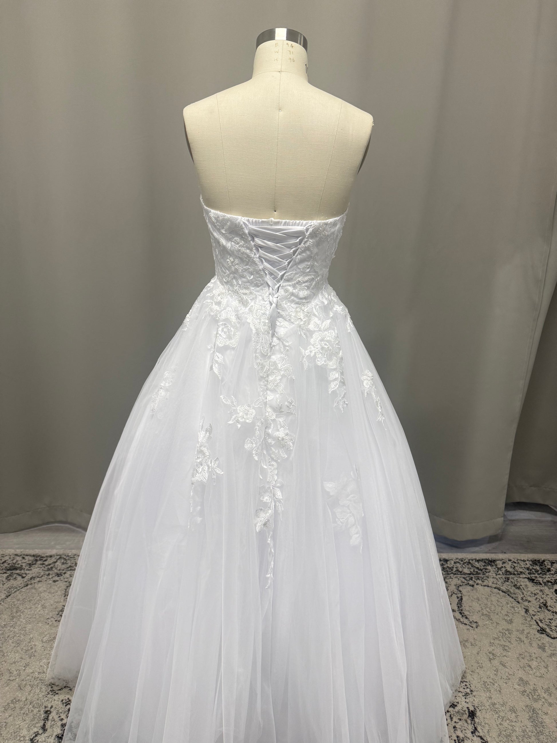 Natalie V1 cascading lace debutante dress back view with lace-up corset