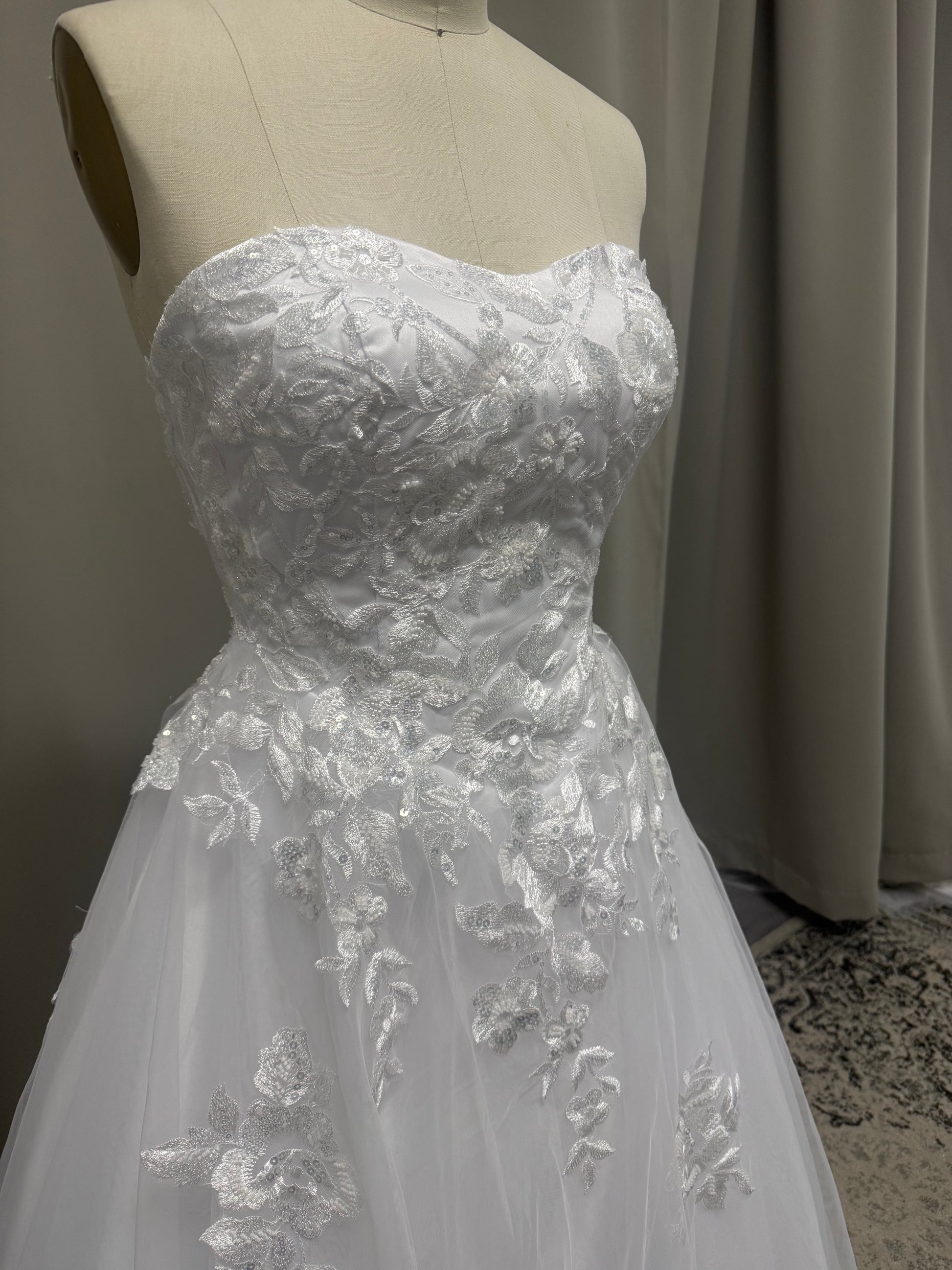Close-up of Natalie V1 cascading lace debutante dress beaded floral lace bodice