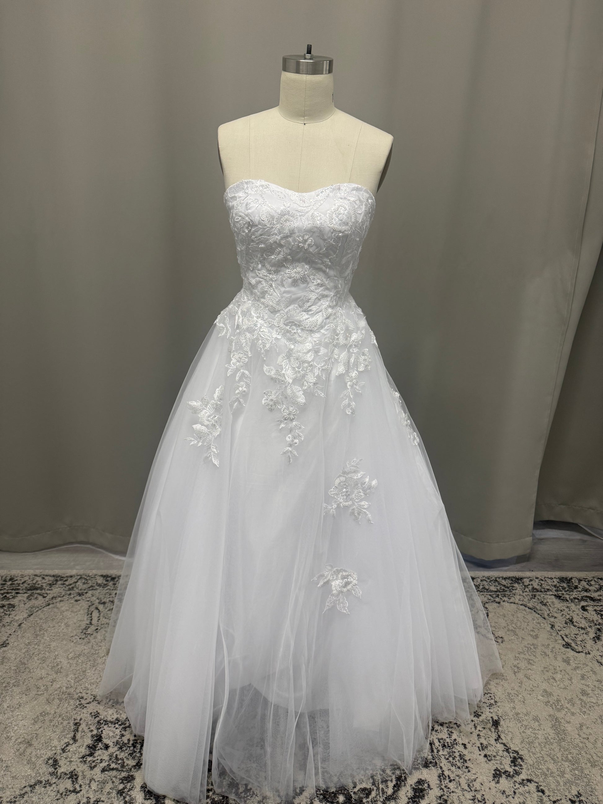 Natalie V1 white cascading lace debutante dress, front view on mannequin