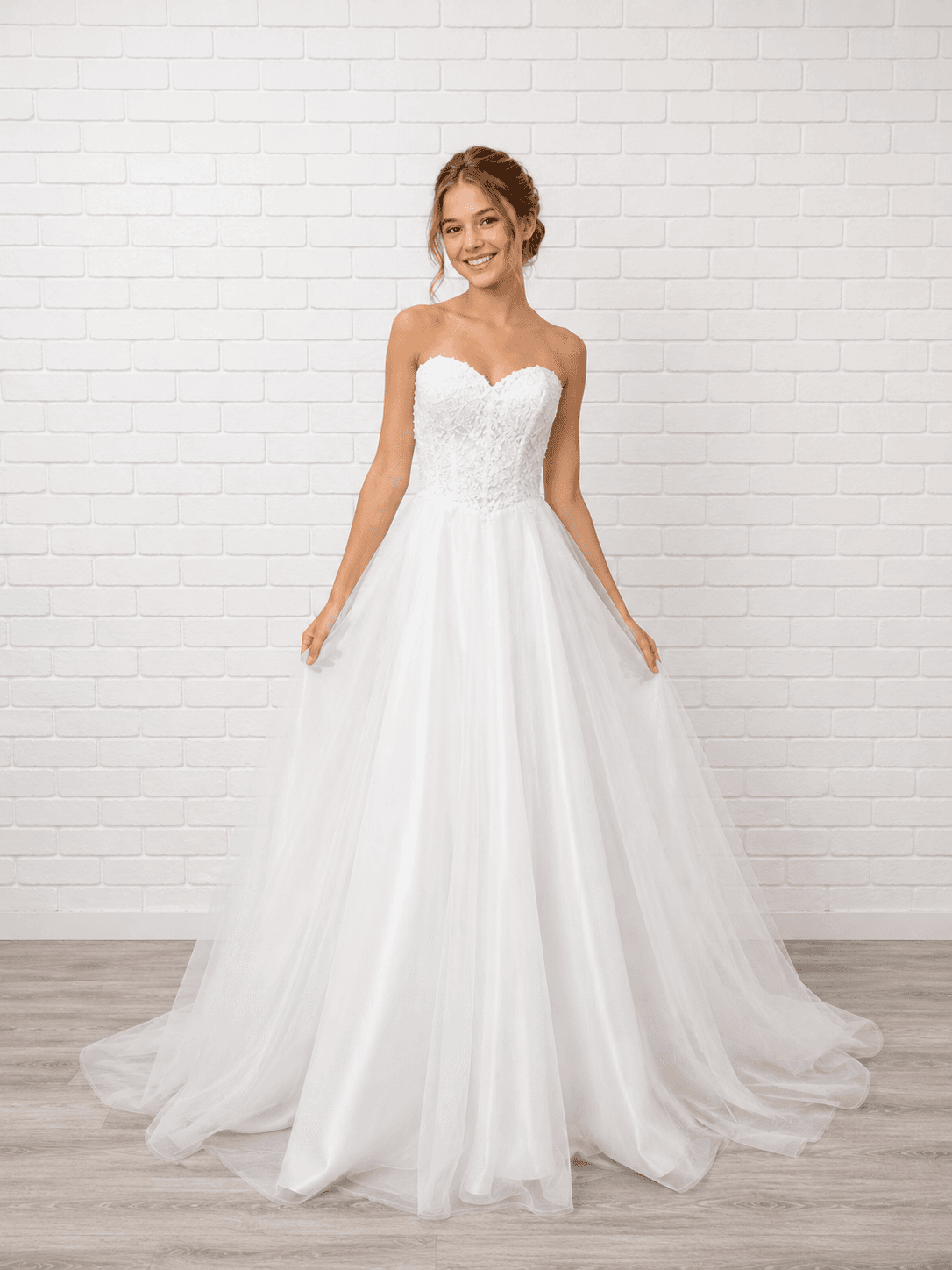 White debutante dress with a strapless lace bodice, lace-up corset back and full A-line tulle skirt.