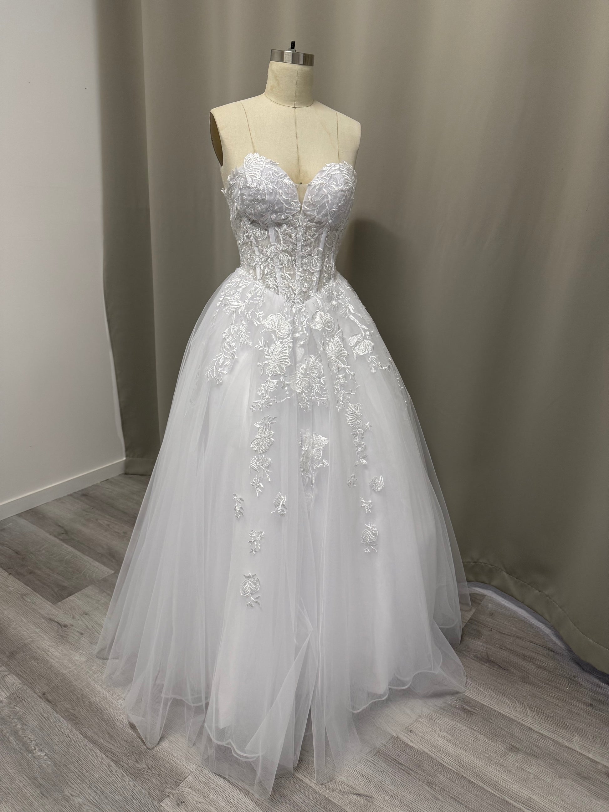 Close-up of Paris Debutante Ball Gown corset bodice with intricate white floral lace appliques and lace-up detailing