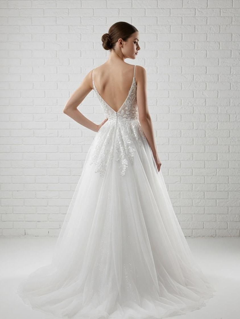 White debutante gown with a low V-back, delicate lace detailing and a full tulle skirt.