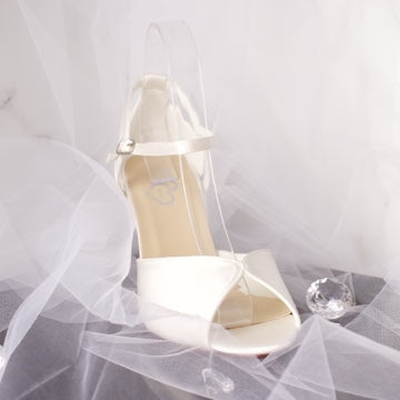 Remi satin bridal shoe with elegant crossover ankle strap.